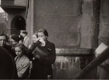 Movie still from “Mirror” (1975), directed by Andrei Tarkovsky – A group of people standing next to each other on the street; Medium shot, High angle