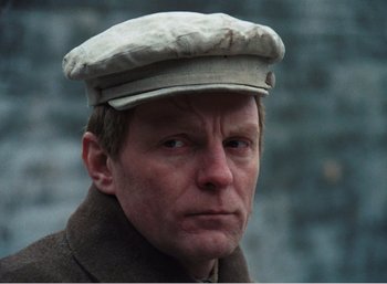 Movie still from “Mirror” (1975), directed by Andrei Tarkovsky – A person wearing a hat; Close Up shot, Low angle