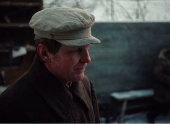 Movie still from “Mirror” (1975), directed by Andrei Tarkovsky – A man wearing a hat and a coat; Close Up shot, Over the shoulder angle