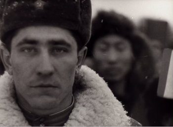 Movie still from “Mirror” (1975), directed by Andrei Tarkovsky – A black and white photo of a man in a military uniform; Close Up shot, Low angle