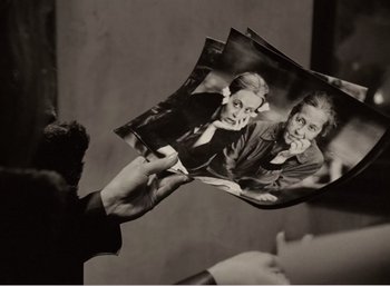 Movie still from “Mirror” (1975), directed by Andrei Tarkovsky – A person holding a picture of a woman; Close Up shot, Overhead angle