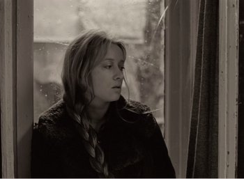 Movie still from “Mirror” (1975), directed by Andrei Tarkovsky – A black and white photo of a woman looking out of a window; Close Up shot, High angle