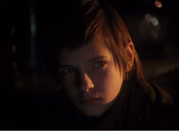 Movie still from “Mirror” (1975), directed by Andrei Tarkovsky – A young boy is looking into the camera; Close Up shot, High angle