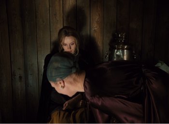 Movie still from “Mirror” (1975), directed by Andrei Tarkovsky – A man and a woman sitting next to each other in a room; Medium shot, High angle
