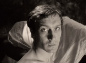 Movie still from “Mirror” (1975), directed by Andrei Tarkovsky – A black - and - white photo of a man's face; Close Up shot, High angle