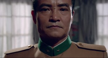 Movie still from “Mishima: A Life in Four Chapters” (1985), directed by Paul Schrader – A person wearing a military uniform; Close Up shot, Low angle