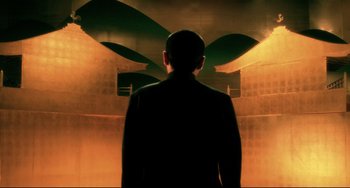 Movie still from “Mishima: A Life in Four Chapters” (1985), directed by Paul Schrader – A man standing in front of a wall; Extreme Wide shot, Low angle