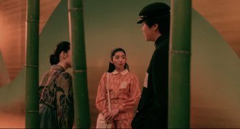 Movie still from “Mishima: A Life in Four Chapters” (1985), directed by Paul Schrader – A group of people standing next to each other in a room; Medium shot, Over the shoulder angle