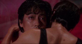 Movie still from “Mishima: A Life in Four Chapters” (1985), directed by Paul Schrader – A man is hugging another man with his arm around another man; Close Up shot, Low angle