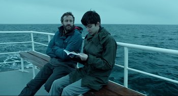 Movie still from “Miss Peregrine's Home for Peculiar Children” (2016), directed by Tim Burton – Two people sitting on a boat looking at a book; Medium shot, Over the shoulder angle