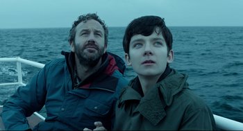 Movie still from “Miss Peregrine's Home for Peculiar Children” (2016), directed by Tim Burton – Two people standing next to each other near the ocean; Close Up shot, Low angle
