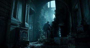 Movie still from “Miss Peregrine's Home for Peculiar Children” (2016), directed by Tim Burton – A man and a woman are walking through an abandoned building; Wide shot, Low angle