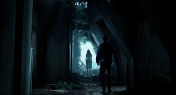 Movie still from “Miss Peregrine's Home for Peculiar Children” (2016), directed by Tim Burton – A man and a woman are walking through a tunnel; Wide shot, Low angle