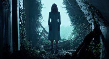 Movie still from “Miss Peregrine's Home for Peculiar Children” (2016), directed by Tim Burton – A woman standing in the middle of a forest; Wide shot, Low angle