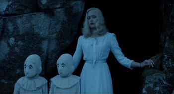 Movie still from “Miss Peregrine's Home for Peculiar Children” (2016), directed by Tim Burton – A woman in a white dress holding a white doll; Medium shot, Low angle