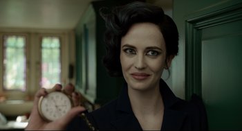 Movie still from “Miss Peregrine's Home for Peculiar Children” (2016), directed by Tim Burton – A woman is smiling while holding a clock in her hand; Close Up shot, Over the shoulder angle