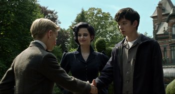 Movie still from “Miss Peregrine's Home for Peculiar Children” (2016), directed by Tim Burton – A man and two women shaking hands in front of trees; Medium shot, Over the shoulder angle
