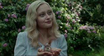Movie still from “Miss Peregrine's Home for Peculiar Children” (2016), directed by Tim Burton – A woman holding a squirrel in her hands; Close Up shot, Over the shoulder angle