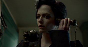 Movie still from “Miss Peregrine's Home for Peculiar Children” (2016), directed by Tim Burton – A woman holding a cell phone up to her ear; Close Up shot, Low angle