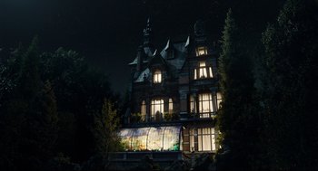 Movie still from “Miss Peregrine's Home for Peculiar Children” (2016), directed by Tim Burton – A large building with a lot of windows at night time; Extreme Wide shot, Low angle