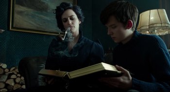 Movie still from “Miss Peregrine's Home for Peculiar Children” (2016), directed by Tim Burton – A woman and a man are smoking and looking at an open book; Medium shot, Low angle
