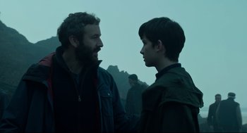 Movie still from “Miss Peregrine's Home for Peculiar Children” (2016), directed by Tim Burton – Two people talking to each other in a field; Medium shot, Over the shoulder angle