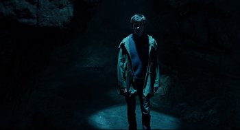 Movie still from “Miss Peregrine's Home for Peculiar Children” (2016), directed by Tim Burton – A man standing in the dark in a cave; Medium shot, High angle