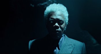 Movie still from “Miss Peregrine's Home for Peculiar Children” (2016), directed by Tim Burton – A man in a suit and tie in the dark; Close Up shot, Low angle