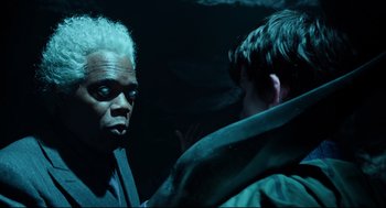 Movie still from “Miss Peregrine's Home for Peculiar Children” (2016), directed by Tim Burton – Two people are talking in the dark; Close Up shot, Over the shoulder angle