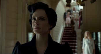 Movie still from “Miss Peregrine's Home for Peculiar Children” (2016), directed by Tim Burton – A woman in a black jacket standing in front of a staircase; Close Up shot, Low angle