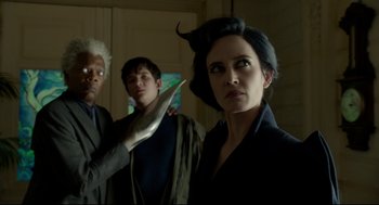 Movie still from “Miss Peregrine's Home for Peculiar Children” (2016), directed by Tim Burton – A group of people standing next to each other in a room; Medium shot, Low angle