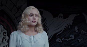 Movie still from “Miss Peregrine's Home for Peculiar Children” (2016), directed by Tim Burton – A woman with blonde curly hair standing in front of a wall; Medium shot, Over the shoulder angle