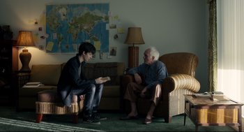 Movie still from “Miss Peregrine's Home for Peculiar Children” (2016), directed by Tim Burton – A man and a woman sitting on a couch; Wide shot, Over the shoulder angle