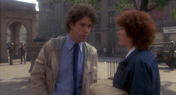 Movie still from “Missing” (1982), directed by Costa-Gavras – A man and a woman are standing in front of each other; Medium shot, Over the shoulder angle