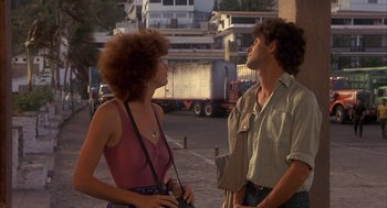 Movie still from “Missing” (1982), directed by Costa-Gavras – A man and a woman standing next to each other on the street; Medium shot, Low angle