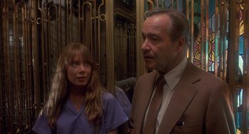 Movie still from “Missing” (1982), directed by Costa-Gavras – A man and a woman standing next to each other in front of a building; Medium shot, Low angle