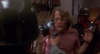 Movie still from “Missing” (1982), directed by Costa-Gavras – A woman getting her hair brushed by a man; Close Up shot, Over the shoulder angle