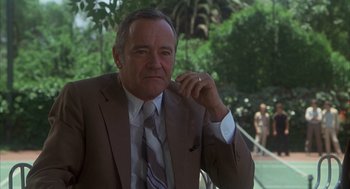 Movie still from “Missing” (1982), directed by Costa-Gavras – An older man wearing a suit and tie; Close Up shot, Low angle