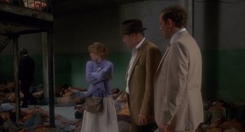 Movie still from “Missing” (1982), directed by Costa-Gavras – A group of men and women standing next to each other; Wide shot, High angle