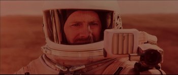 Movie still from “Mission to Mars” (2000), directed by Brian De Palma – A man in a spacesuit is looking into a camera; Close Up shot, Over the shoulder angle