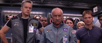 Movie still from “Mission to Mars” (2000), directed by Brian De Palma – A group of people standing next to each other wearing space suits; Medium shot, Low angle