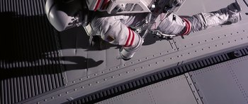 Movie still from “Mission to Mars” (2000), directed by Brian De Palma – An image of an astronaut on a space ship; Wide shot, Overhead angle