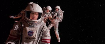 Movie still from “Mission to Mars” (2000), directed by Brian De Palma – A group of people in spacesuits in the stars; Medium shot, Overhead angle