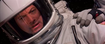 Movie still from “Mission to Mars” (2000), directed by Brian De Palma – A man in a spacesuit looking into a mirror; Close Up shot, Overhead angle