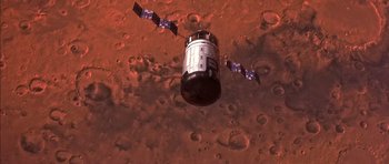 Movie still from “Mission to Mars” (2000), directed by Brian De Palma – An image of a satellite in the middle of the desert; Extreme Wide shot, Overhead angle
