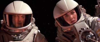 Movie still from “Mission to Mars” (2000), directed by Brian De Palma – Two people in spacesuits are looking into the distance; Close Up shot, Overhead angle
