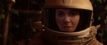 Movie still from “Mission to Mars” (2000), directed by Brian De Palma – A woman wearing a space helmet looking into a mirror; Close Up shot, Over the shoulder angle