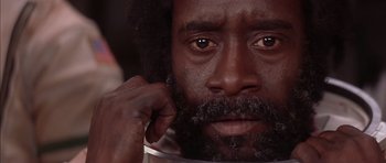 Movie still from “Mission to Mars” (2000), directed by Brian De Palma – A person with a beard looking at the camera; Extreme Close Up shot, Low angle