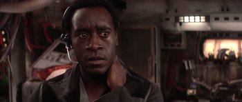 Movie still from “Mission to Mars” (2000), directed by Brian De Palma – A person with his hand on his neck; Close Up shot, Low angle