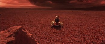 Movie still from “Mission to Mars” (2000), directed by Brian De Palma – An image of a person on a vehicle in the desert; Extreme Wide shot, High angle